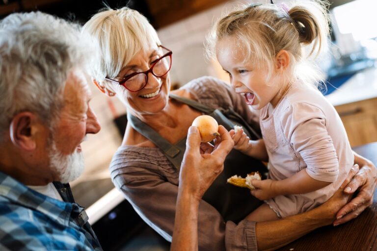 Happy grandparents having fun times with children at home