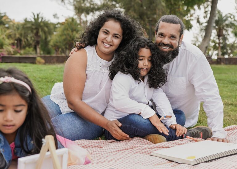 Family of four enjoying a day out in a city park