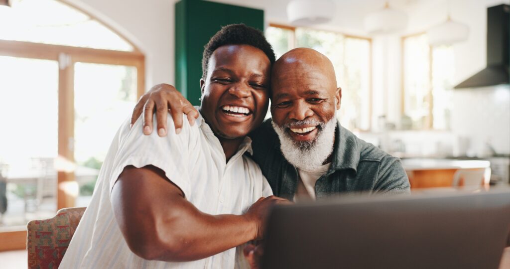 Success, hug and senior father with son and laptop for good news, achievement and job promotion. S