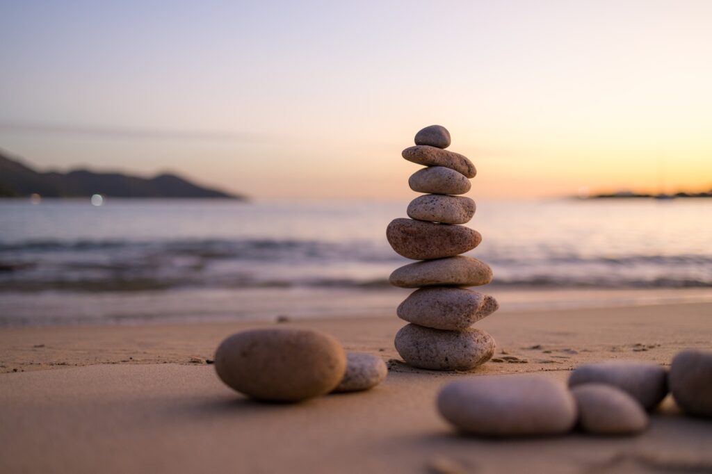 Zen stones on the beach in sunset time